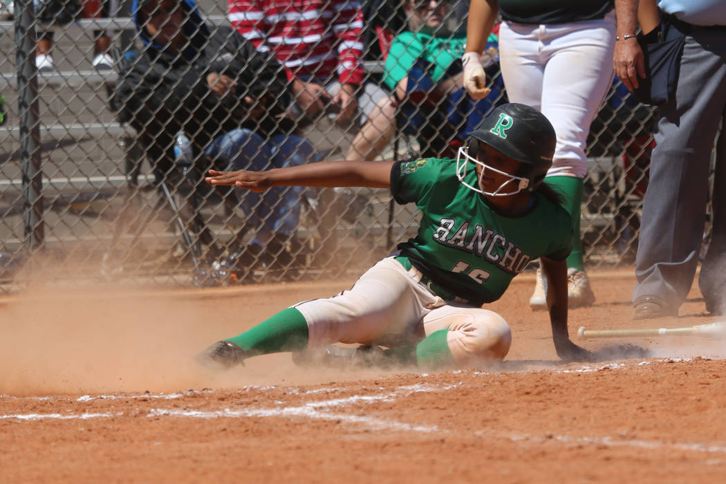 Rancho's Anaiya Irick (16) slides home for a run against Desert Oasis in the softball game at D ...