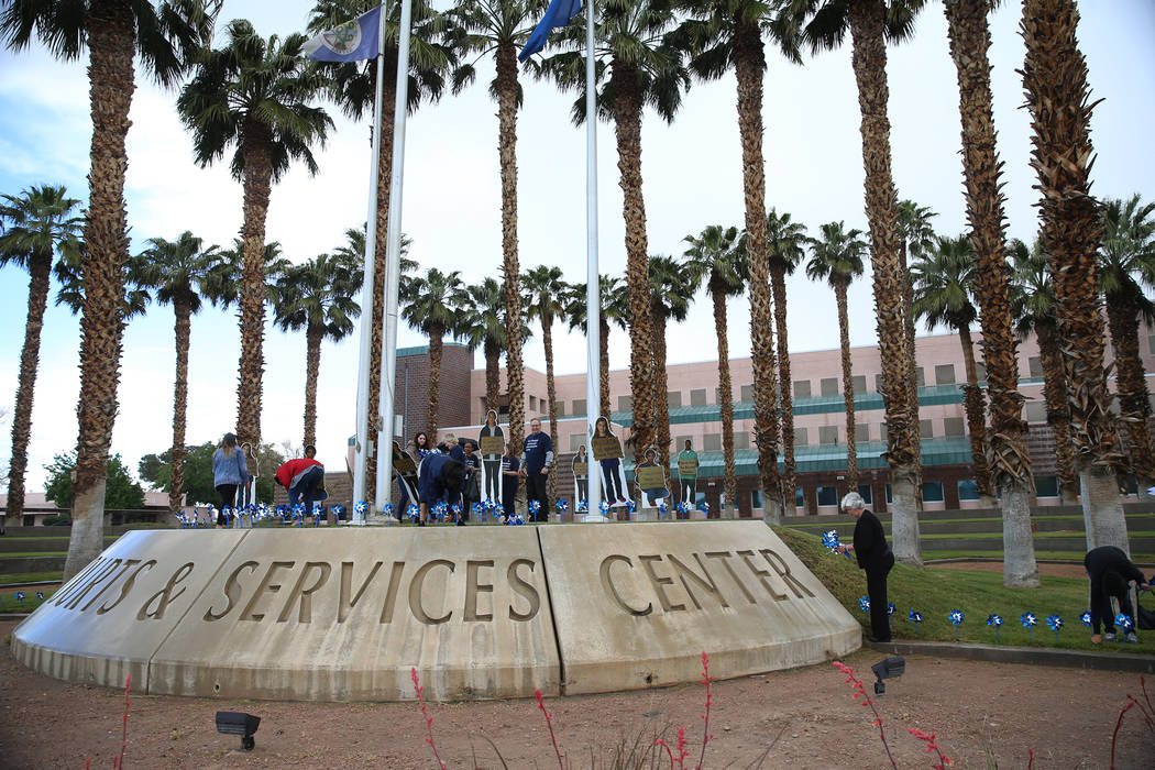 Volunteers plant 450 pinwheels outside of the Eighth Judicial District Family Court in Las Vega ...
