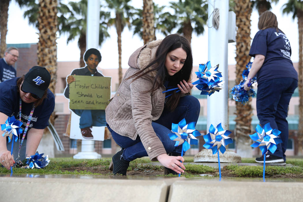 Volunteers plant 450 pinwheels outside of the Eighth Judicial District Family Court in Las Vega ...