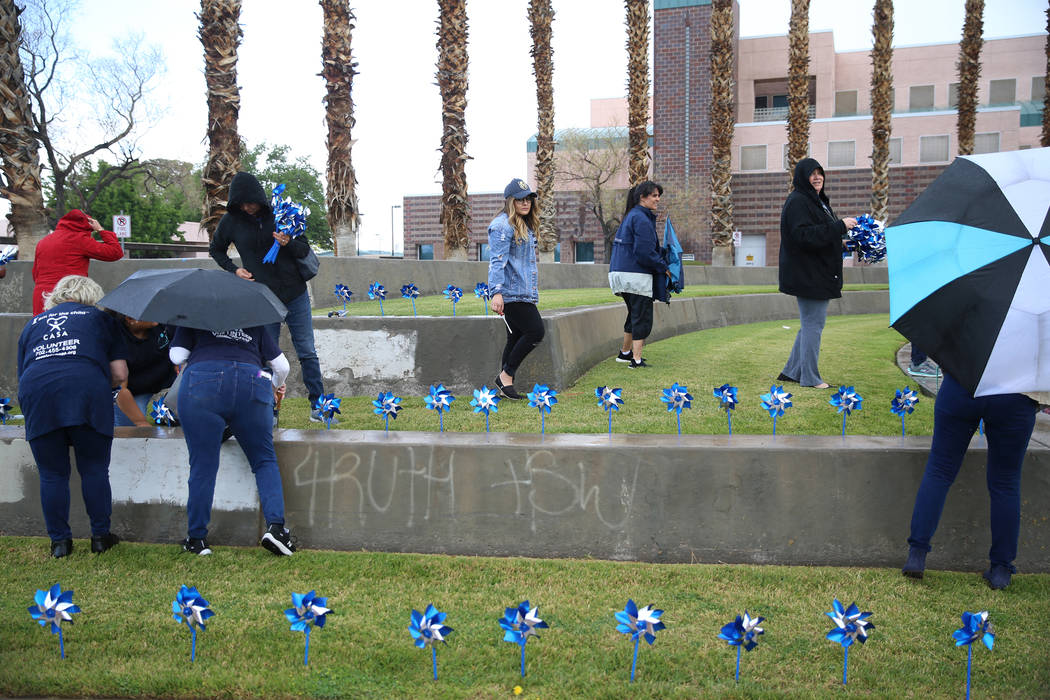 Volunteers plant 450 pinwheels outside of the Eighth Judicial District Family Court in Las Vega ...
