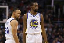 Golden State Warriors guard Stephen Curry (30) and forward Kevin Durant (35) pause during the f ...