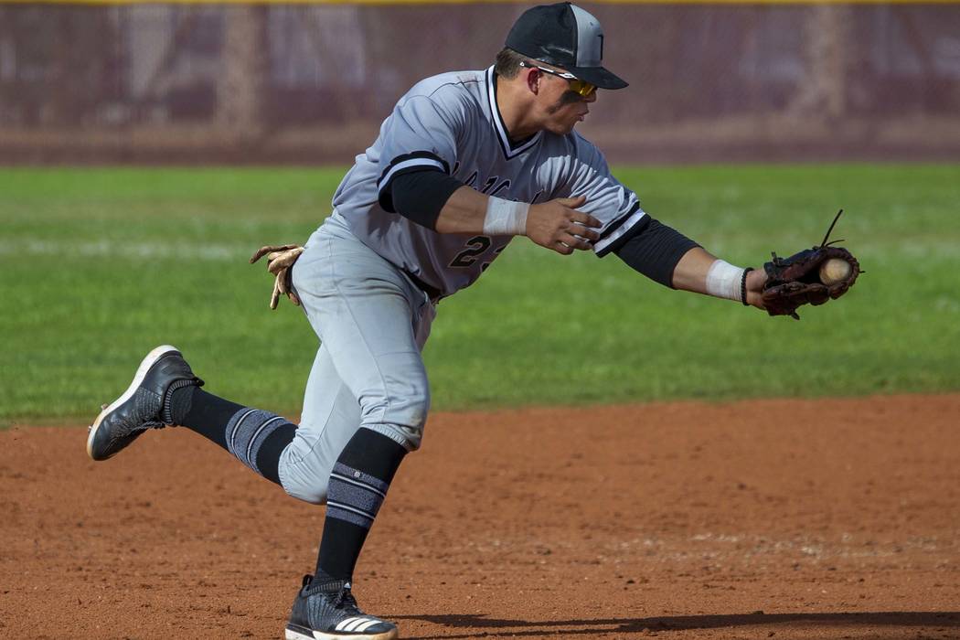 Palo Verde's Paul Myro IV (23) scoops up a grounder from a Faith lutheran batter during their h ...