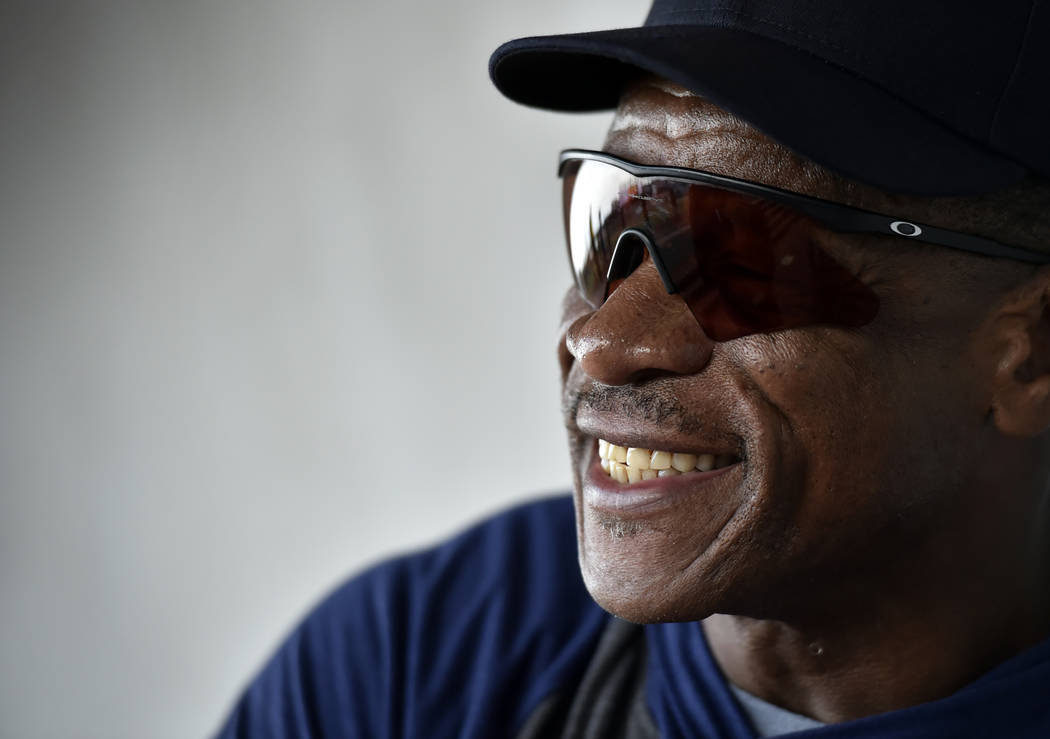 Retired Major League baseball player and special coach Rickey Henderson smiles as he works with ...