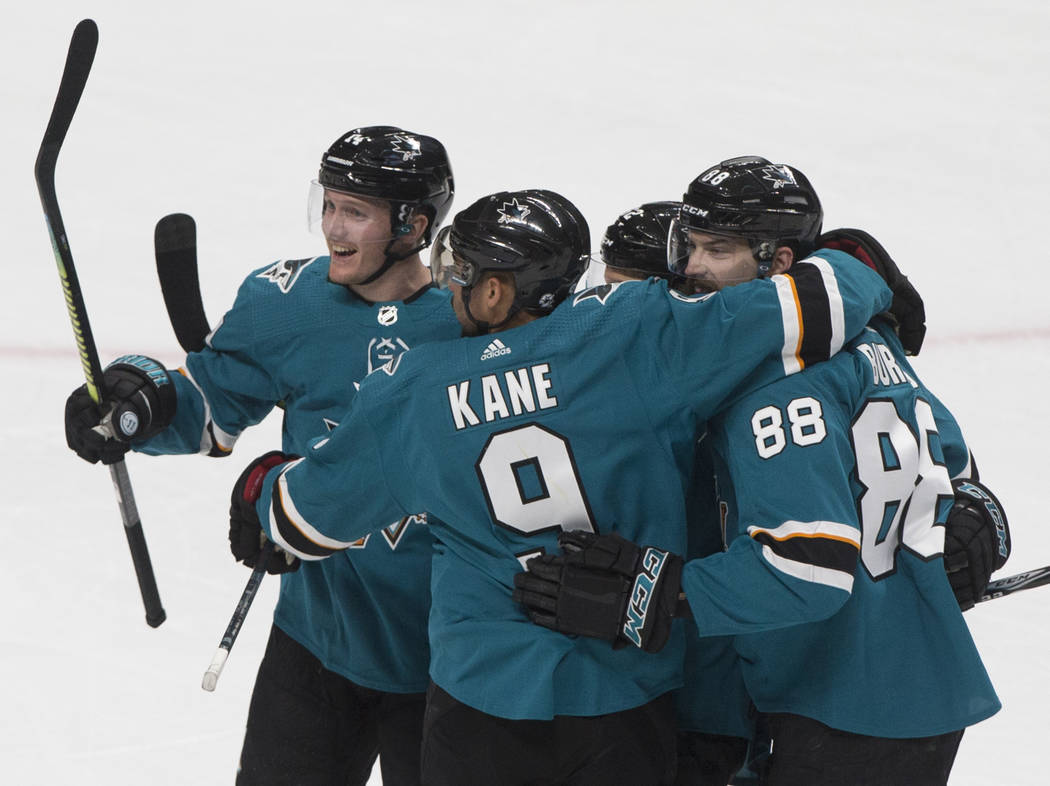 San Jose Sharks left wing Evander Kane (9) celebrates with teammates Brent Burns (88) and Gusta ...