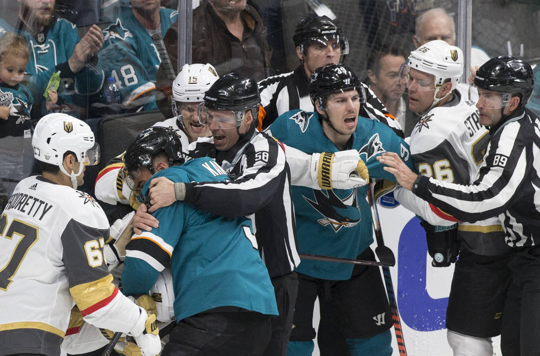 The Golden Knights and San Jose Sharks fight in the first period during Game 1 of an NHL Wester ...