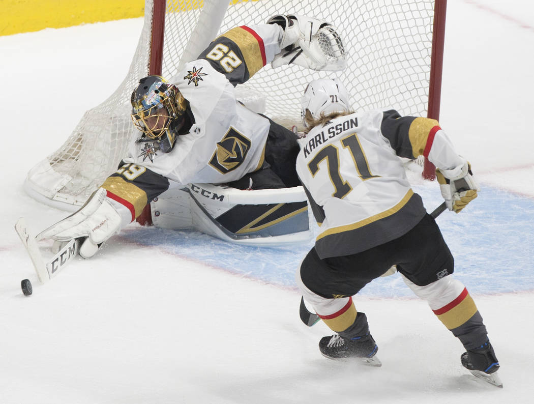 Golden Knights goaltender Marc-Andre Fleury (29) makes a save in the first period with the help ...