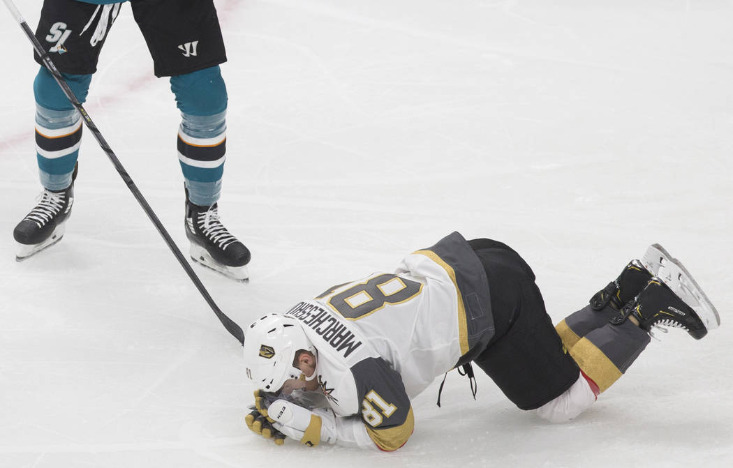 Golden Knights center Jonathan Marchessault (81) holds his face after getting hit by San Jose S ...