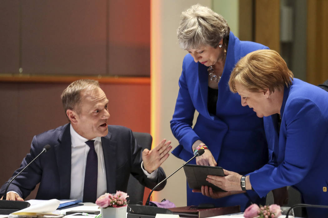 European Council President Donald Tusk, left looks on as Britain's Prime minister Theresa May, ...