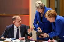 European Council President Donald Tusk, left looks on as Britain's Prime minister Theresa May, ...