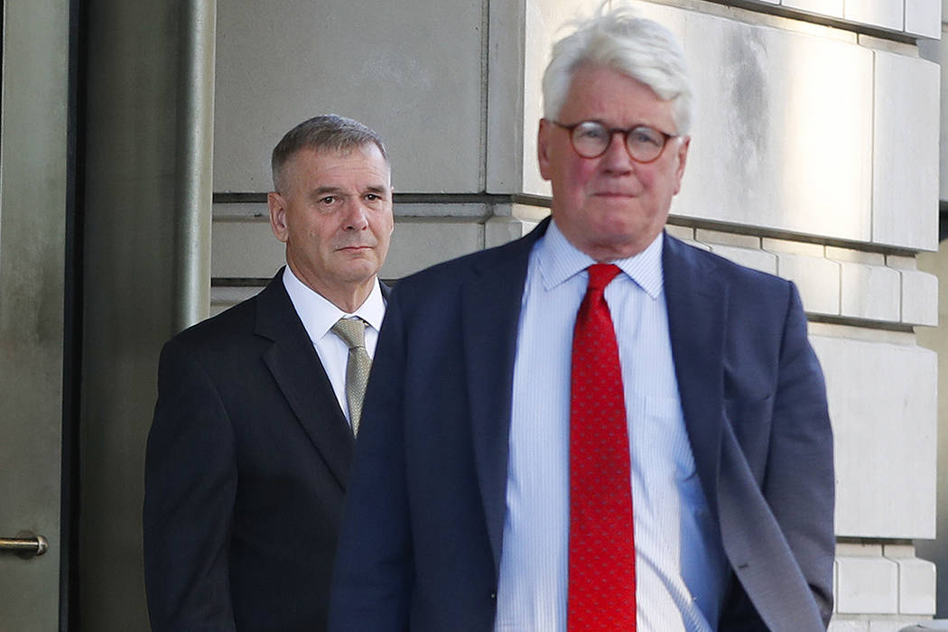 Retired Marine Gen. James Cartwright, left, and attorney Greg Craig leave US District Court in ...