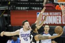 Phoenix Suns center Jack Cooley (45) attempts to block the shot of San Antonio Spurs guard Trey ...
