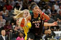 Las Vegas Aces forward Nia Coffey (12) pushes past Los Angeles Sparks guard Karlie Samuelson (4 ...