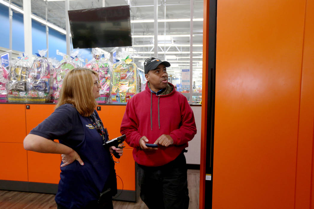 Walmart Associate Molly helps Harold Lloyd with the pickup tower at the Walmart in Henderson, T ...