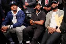 Carmelo Anthony, Chris Paul and LeBron James, from left, watch during the first half of an NBA ...