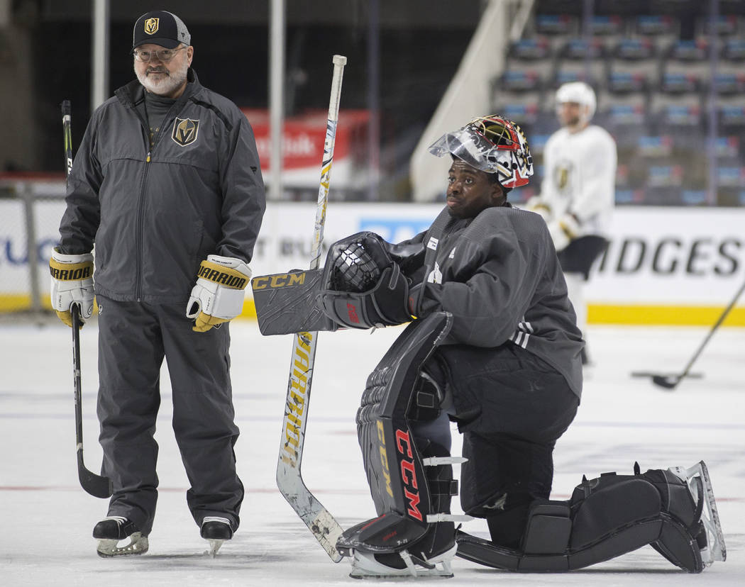 Golden Knights goaltender Malcolm Subban, right, takes a break during practice on Thursday, Apr ...