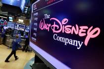 The Walt Disney Co. logo appears on a screen above the floor of the New York Stock Exchange. (A ...