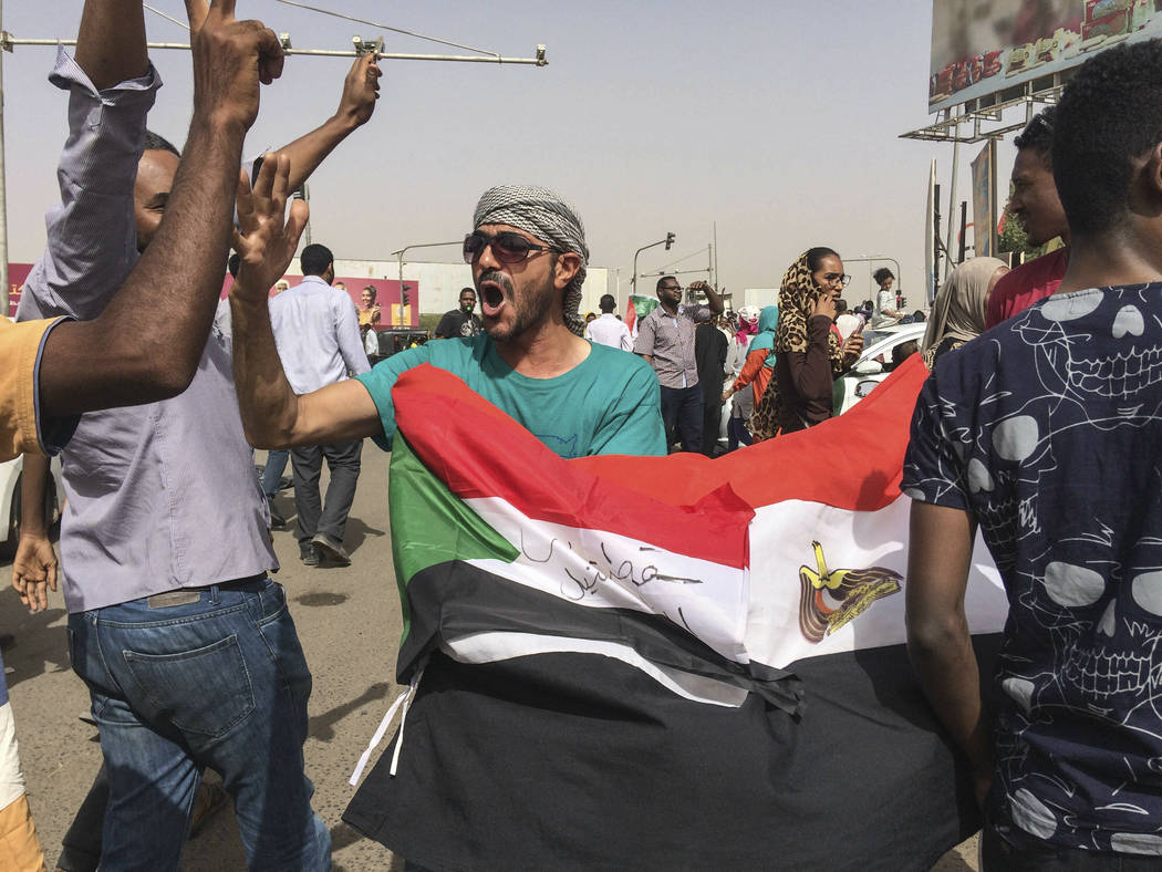Sudanese celebrate after officials said the military had forced longtime autocratic President O ...
