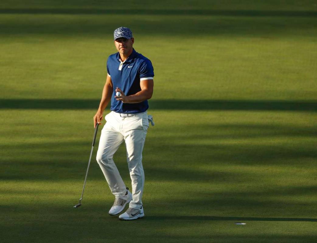 Brooks Koepka reacts after his putt on the 15th hole during the first round for the Masters gol ...