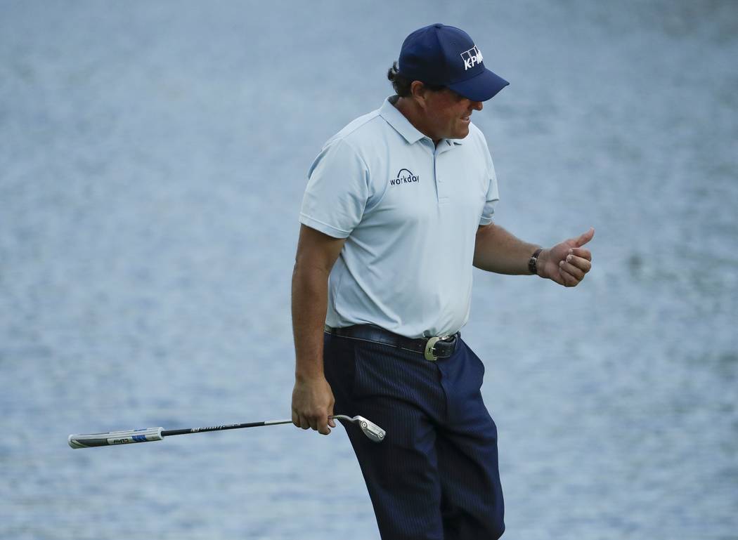 Phil Mickelson reacts after his birdie on the 16th hole during the first round for the Masters ...