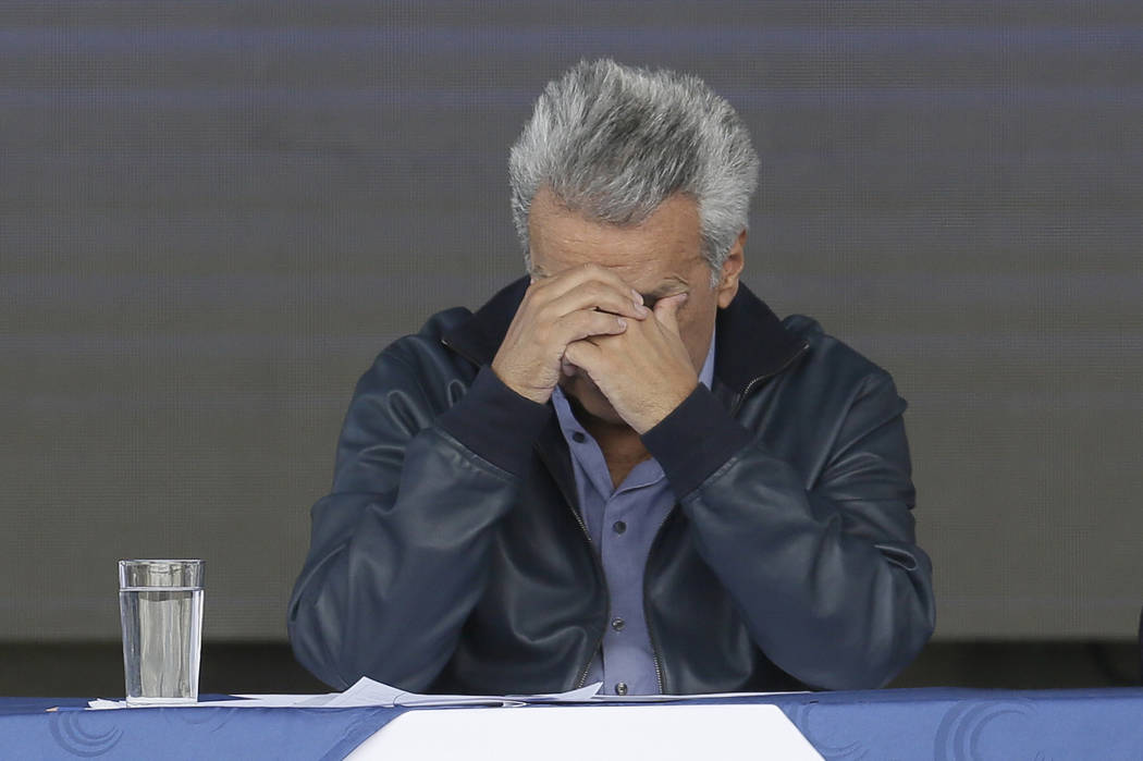 Ecuador's President Lenin Moreno rests his face in his hands during the inauguration of the &qu ...
