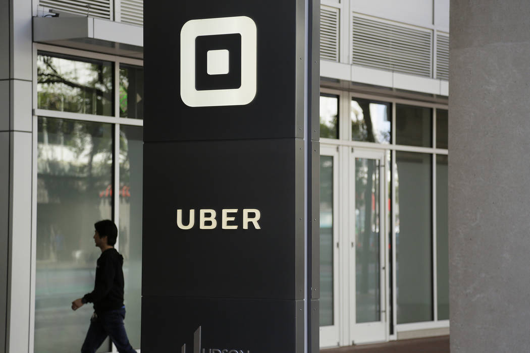 A man walks into the building that houses the headquarters of Uber in San Francisco on June 21, ...