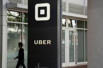 A man walks into the building that houses the headquarters of Uber in San Francisco on June 21, ...