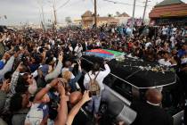 A hearse carrying the casket of slain rapper Nipsey Hussle passes through the crowd Thursday, A ...