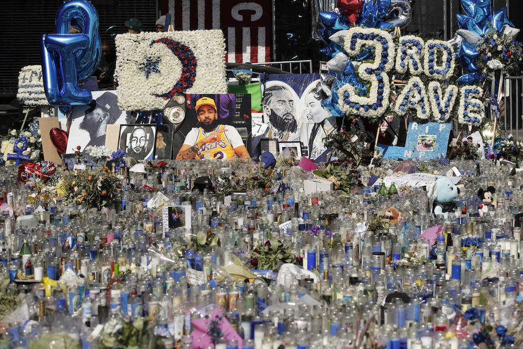 A makeshift memorial site for slain rapper Nipsey Hussle is filled with candles outside The Mar ...