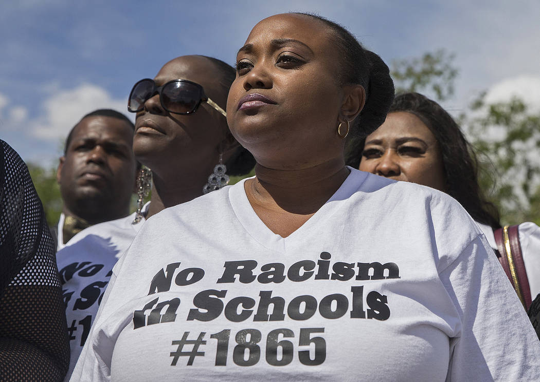 Jshauntae Marshall wears a "No Racism in Schools #1865" shirt during a press conference outside ...