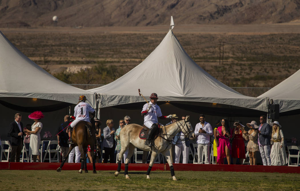 Polo players from UBS Financial Services and Blue Heronshow off their horses to the guests duri ...