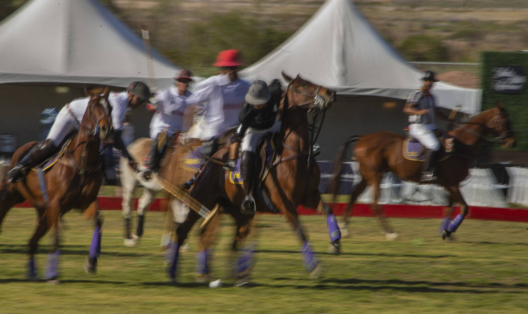 Players from UBS Financial Services and Blue Heron battle for control of the ball during their ...