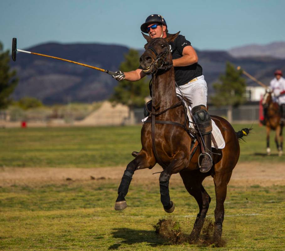 Blue Heron's Dan Faherty (2) sends the ball up the field as his horse leaps versus UBS Financia ...