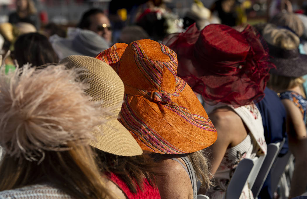 Guests all wear fancy hats as they enjoy Saks Fifth Avenue featuring a formal runway show of s ...