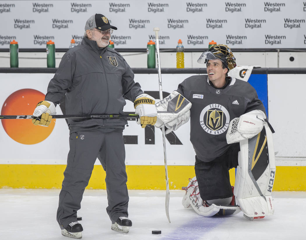 Golden Knights goaltender Marc-Andre Fleury, right, jokes around with Vegas' coaching staff dur ...