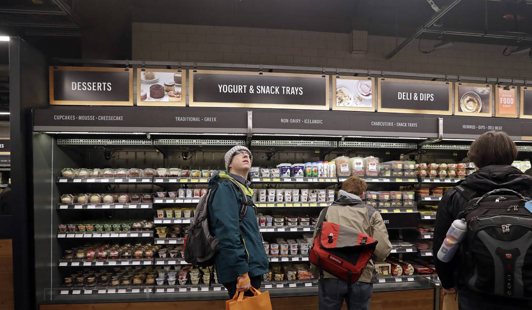 FILE - In this Jan. 22, 2018, file photo, a customer looks overhead in an Amazon Go store, wher ...
