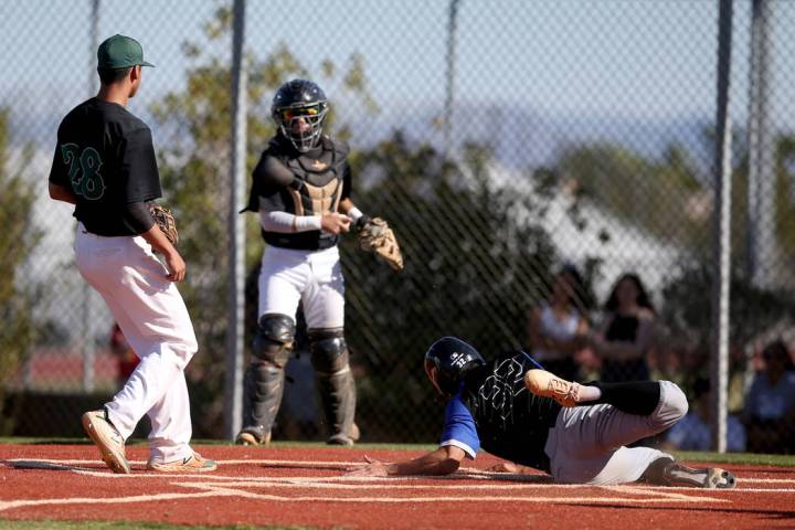 Basic's Logan Spaur (32) scores as Palo Verde catcher Yuta Nakamura holds the throw to pitcher ...