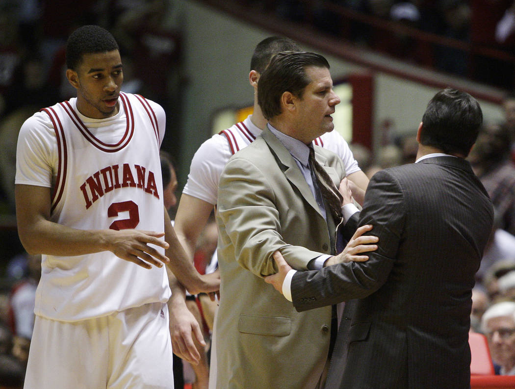 Indiana coach Tom Crean, right, is held back by assistant Tim Buckley after Crean received his ...