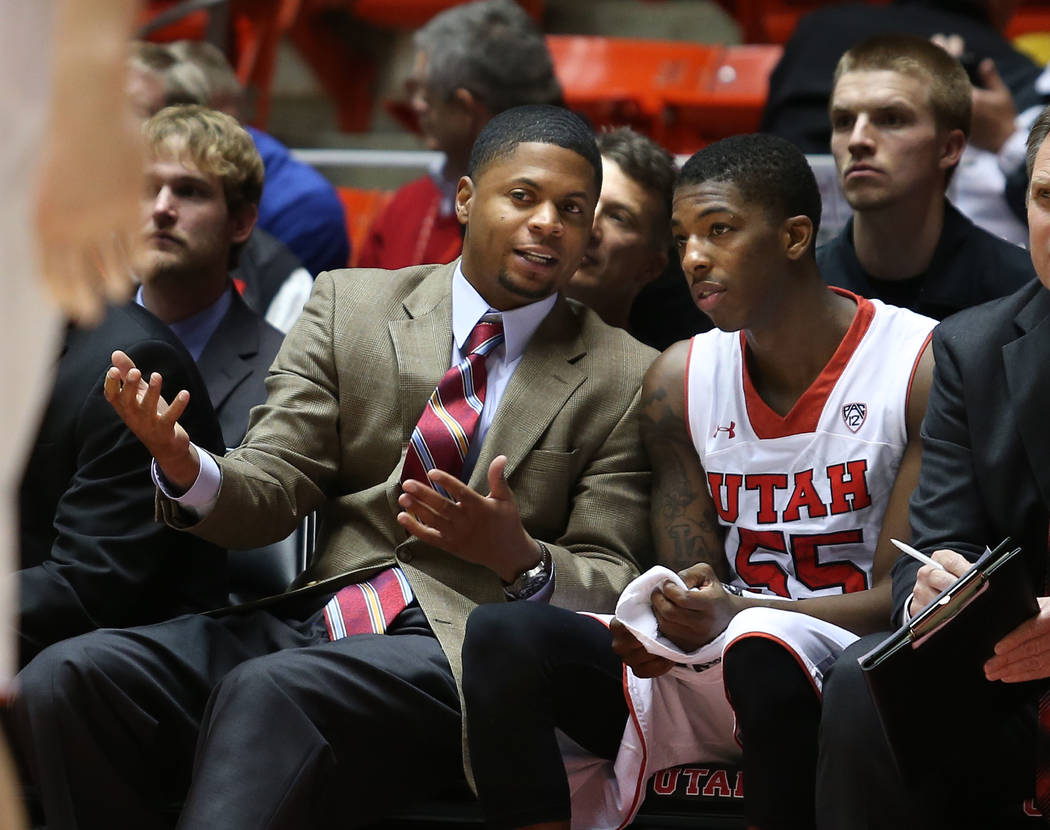 Utah assistant coach DeMarlo Slocum talks with Delon Wright as the University of Utah defeats G ...