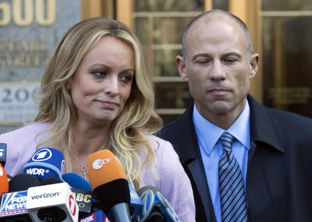 Stormy Daniels, left, stands with her lawyer Michael Avenatti as she speaks outside federal cou ...