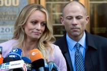 Stormy Daniels, left, stands with her lawyer Michael Avenatti as she speaks outside federal cou ...