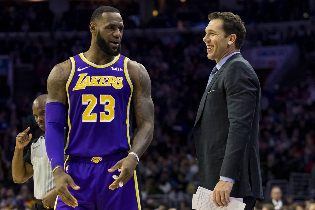 Los Angeles Lakers' head coach Luke Walton, right, talks things over with LeBron James, left, d ...
