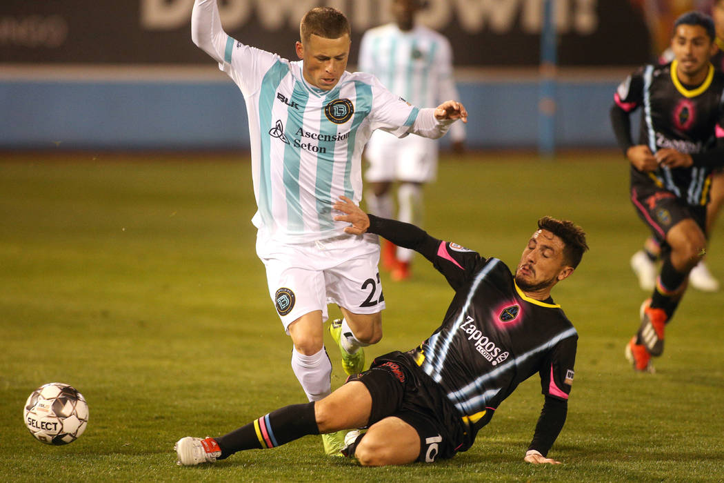 Las Vegas Lights FC midfileder Lucas Scaglia (16) slides into Austin Bold FC forward Clayton Ad ...