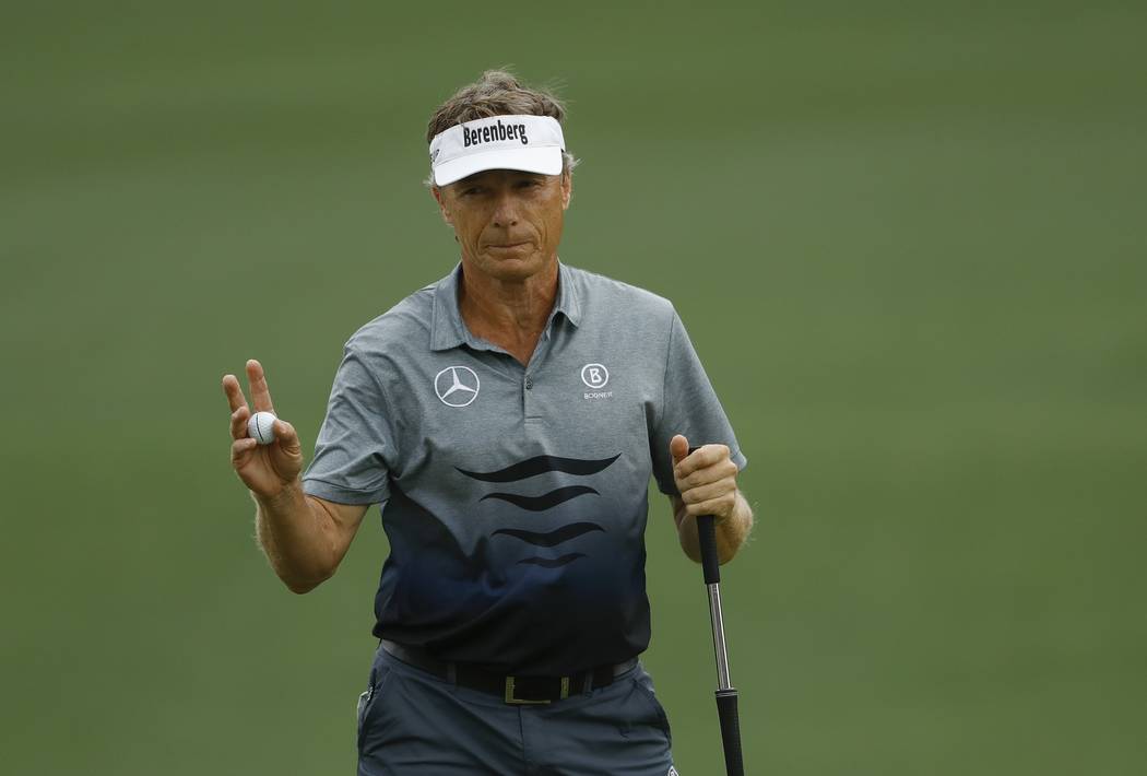 Bernhard Langer, of Germany, waves after putting on the second hole during the second round for ...