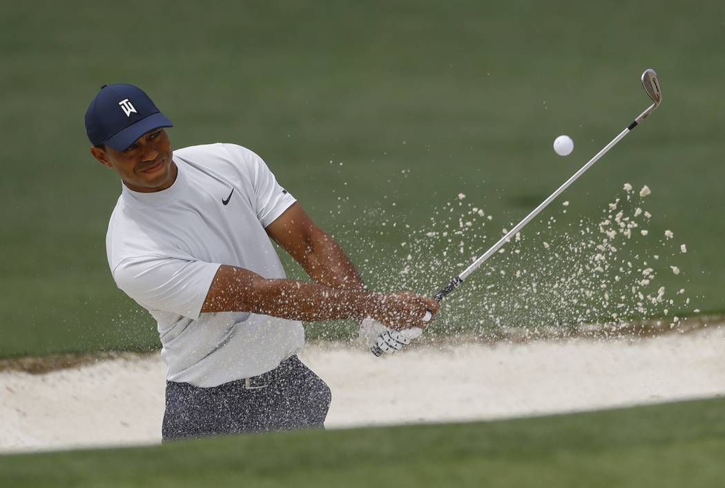 Tiger Woods hits from a bunker on the second hole during the second round for the Masters golf ...