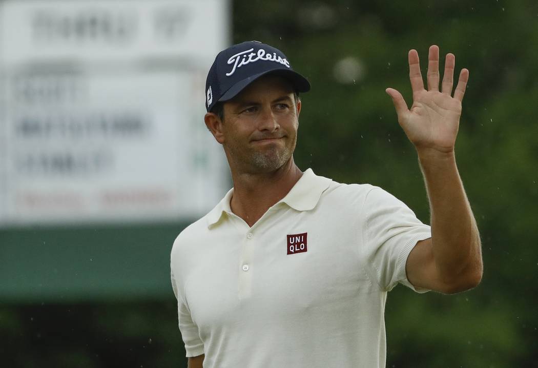 Adam Scott, of Australia, waves as he walks off the 18th green during the second round for the ...