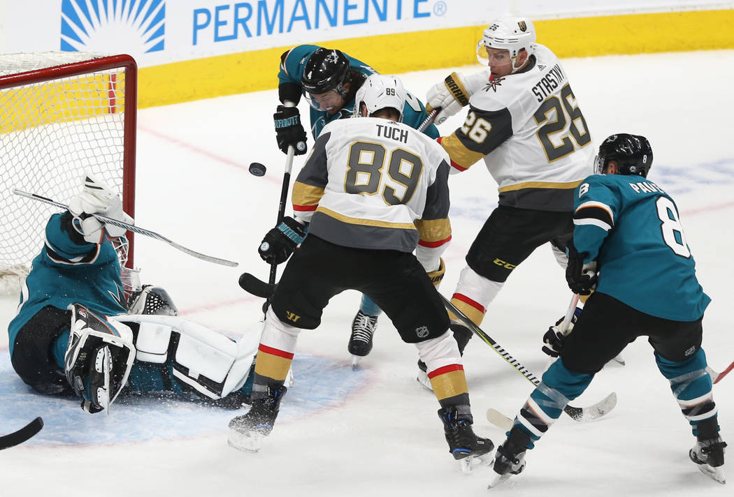 San Jose Sharks goaltender Aaron Dell (30) makes a save against Golden Knights right wing Alex ...