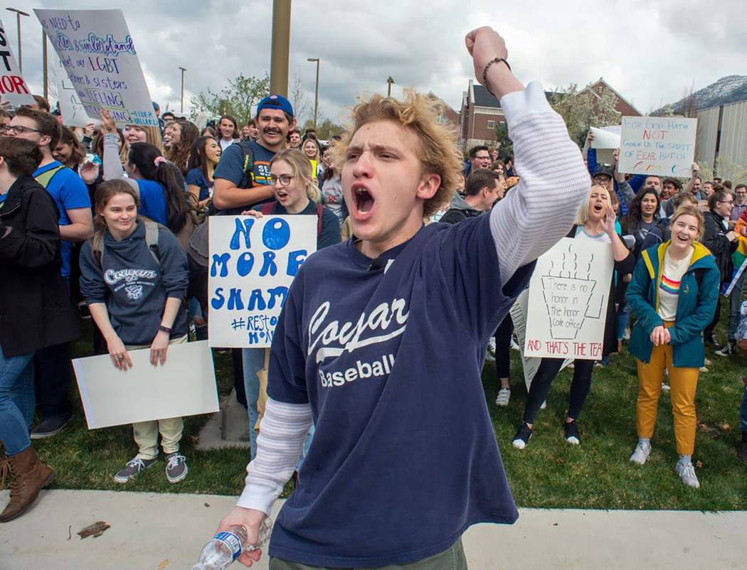 Grant Frazier leads a chant as hundreds of students on the campus of Brigham Young University g ...