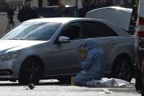 A Forensic officer works at the scene near the Ukrainian Embassy after police fired shots after ...