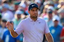 Francesco Molinari waves on the 18th green making a par to finish at 13 under for the lead in t ...