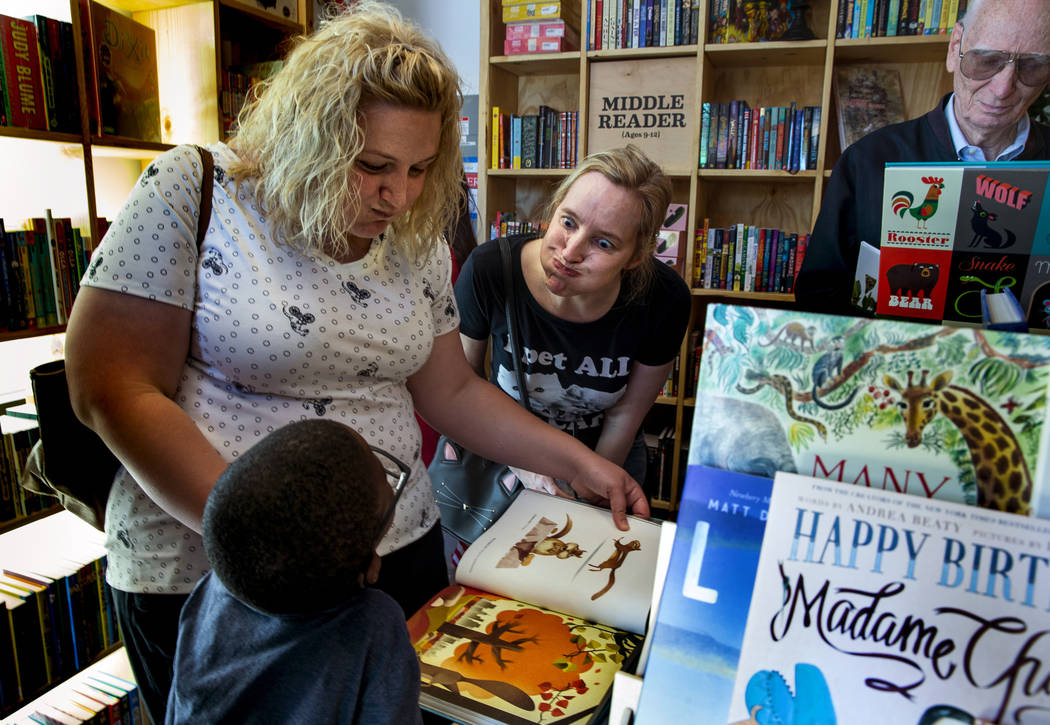 Matthew Graham, 6, Mallory Cyr and Zoe Terry emulate a chipmunk with full cheeks from a book du ...